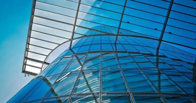 Glass and steel architecture against a blue sky
