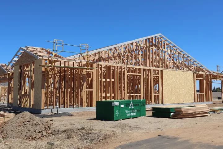A house being framed on a sunny day