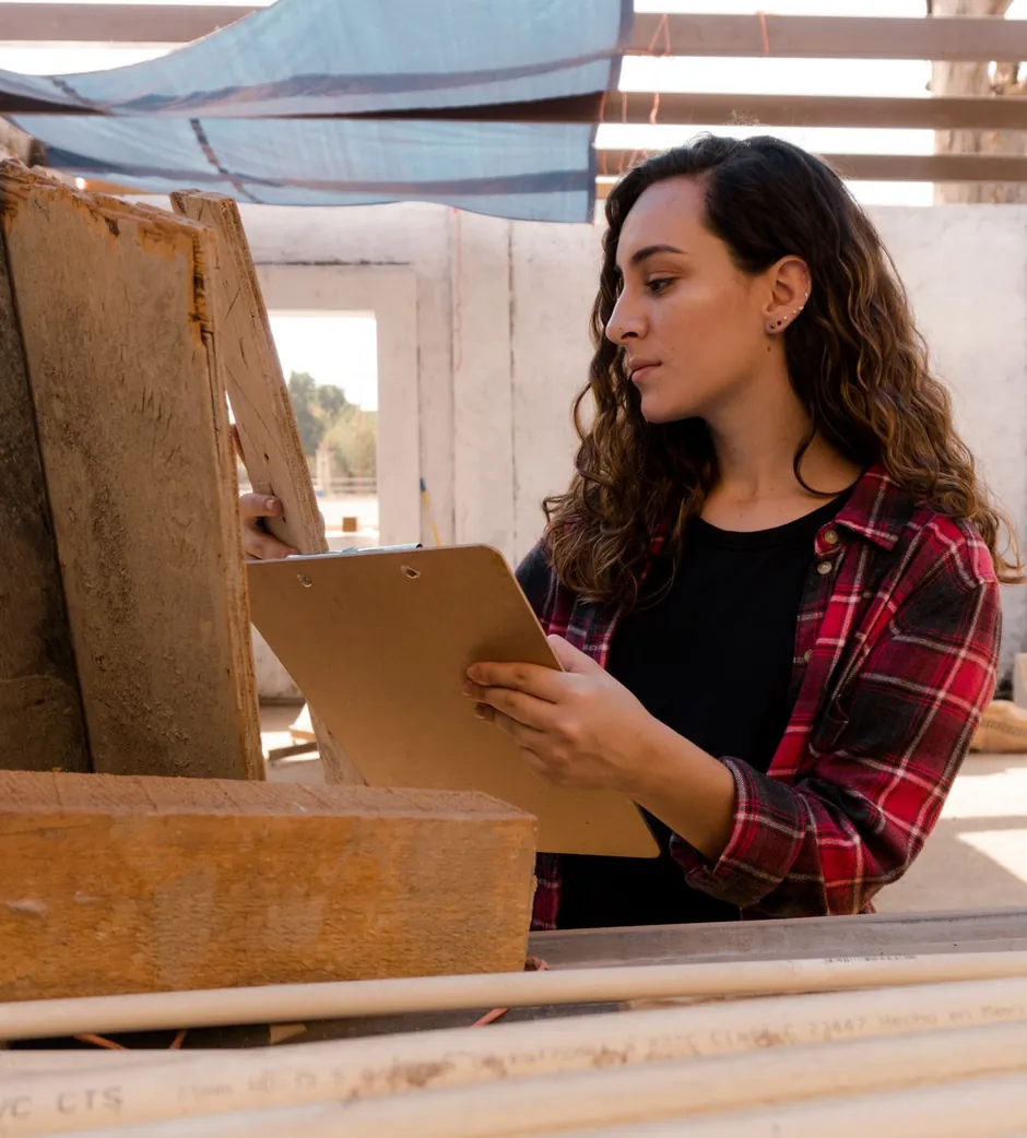 A carpenter reviewing an estimate on a clipboard